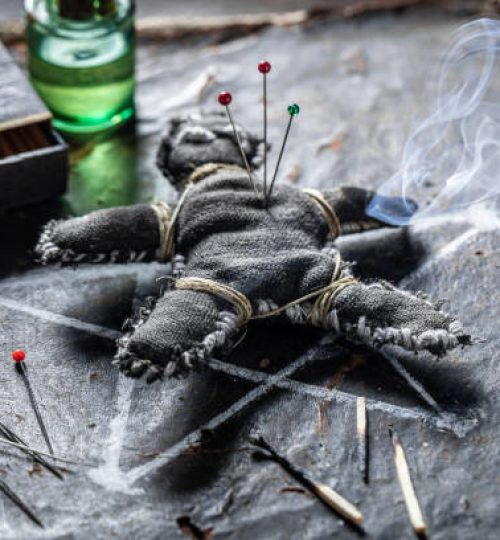 Scary voodoo doll burned with fire as harming