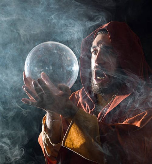 Fortune teller in fantastical costume holding crystal ball